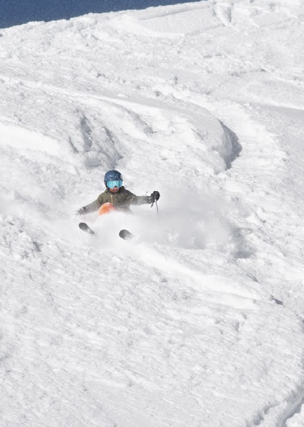 Athlete skiing deep powder